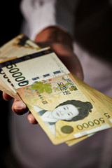 50000 Korean won banknotes in hand 