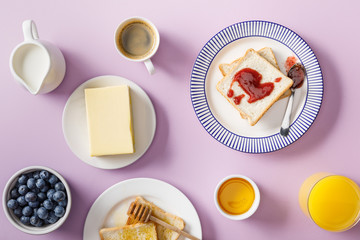 top view of served breakfast on violet background