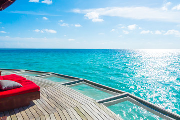 Vacation net seat in tropical Maldives island and beauty of the sea with the coral reefs .