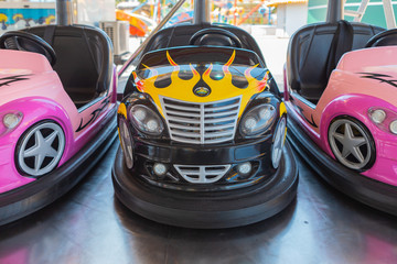Fototapeta na wymiar Small colored bumper cars for children