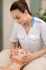 Obraz na płótnie Canvas Dark-haired massage specialist providing service for client