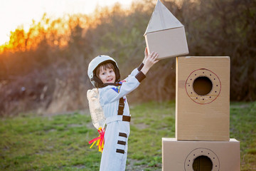 Adorable little boy, dressed as astronaut, playing in park