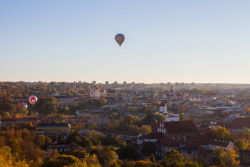 Flight of balloons over the Old Town of Vilnius at sunset. Lithuania