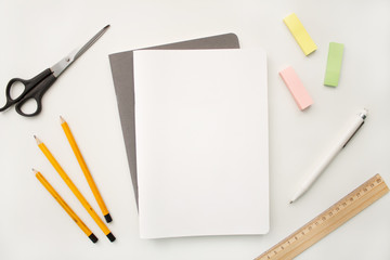 white notebook lies on gray exercise books in the form of letterhead on white backdrop of with a...