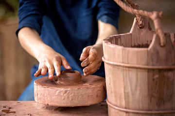 Child making ceramic pot on a farm