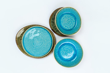 Simple rustic handmade blue crockery  on a white background