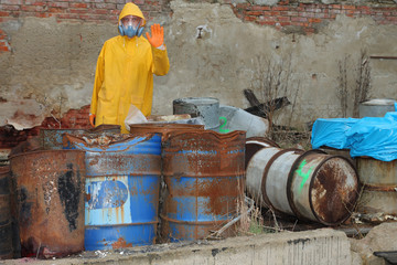 Man with protective  mask and protective clothes explores danger area.