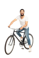 Fototapeta na wymiar cheerful latin man riding bicycle isolated on white