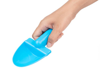 Hand holding Toy plastic blue of shovel isolated on a white background.