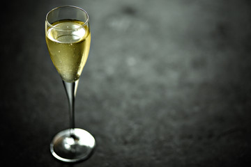 Champagne in a glass on black background