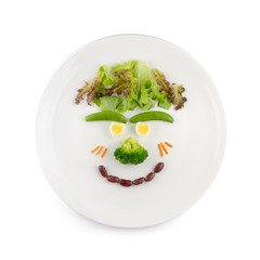 Vegetable salad that is a cartoon face