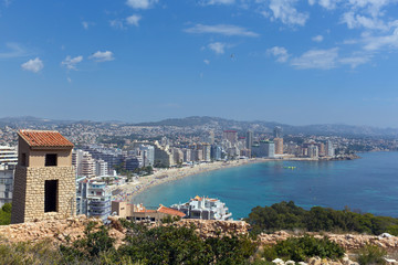 Fototapeta premium La Fossa beach Calp Spain Costa Blanca with people and the famous rock landmark