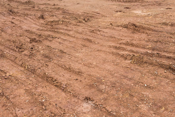 Soil and gravel and wheel prints on engineering land