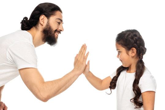cheerful latin father giving five to cute daughter isolated on white