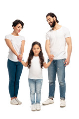 Obraz premium happy latin parents holding hands with cute daughter while standing isolated on white
