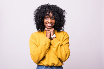 Fototapeta na wymiar Portrait of thoughtful young african american woman with curly black hair with her hand on the chin isolated on white background. Concept of decision making