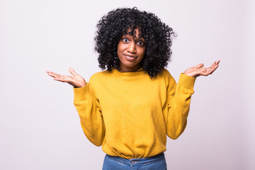 Beautiful young african american woman wearing glasses over isolated background. Smiling showing...