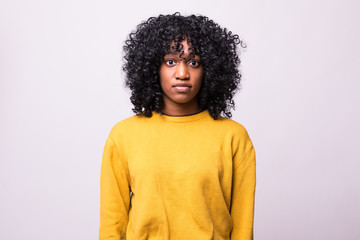 Beautiful african american girl with an afro hairstyle smiling isolated on white background