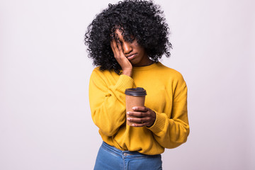 Tired sleepy african woman covers half of face with palm, has sad expression, closes eyes, carries...