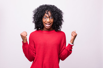 young black woman doing winner gesture isolated on white background