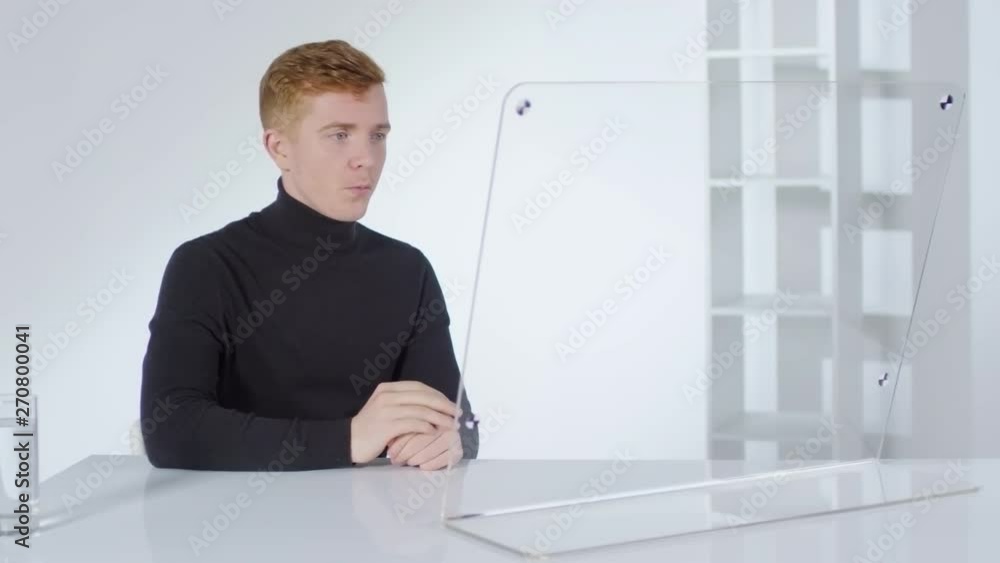 Aufkleber lockdown of young caucasian businessman sitting in office at invisible multi-touch screen and having