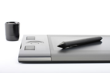A close-up of  pen on graphic tablet on white background