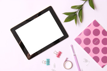 Modern digital tablet and school stationery on a colored background top view. Kontpt back to school. Place for text.