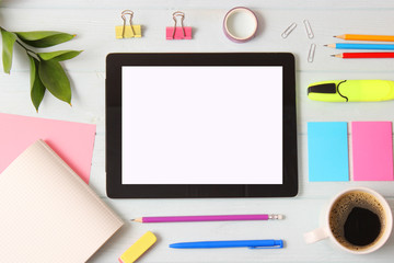 Modern digital tablet and school stationery on a colored background top view. Kontpt back to school. Place for text.