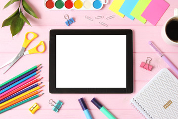 Modern digital tablet and school stationery on a colored background top view. Kontpt back to school. Place for text.