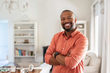 Mature black man with crossed arms looking at camera - Powered by Adobe