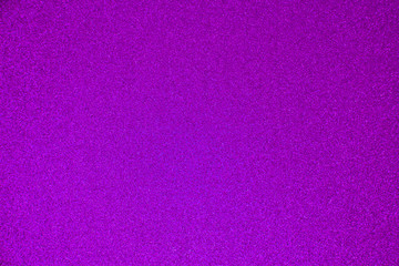 An abstract purple background made of twinkling glitter that is great for a background for Christmas and other celebrations.