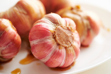 Pickled garlic cloves on white background 