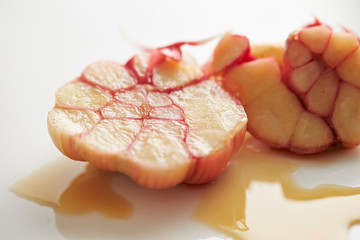 Pickled garlic cloves on white background 