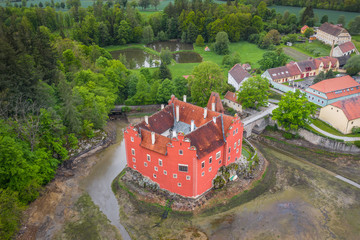 Cervena Lhota château. It stands at the middle of a lake on a rocky island. Its picturesque...