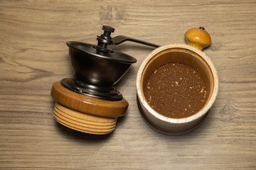 Coffee grinder and bean roast coffee ground on wooden table , background