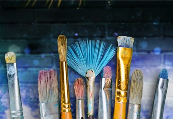 Row of artist paint brushes  on background