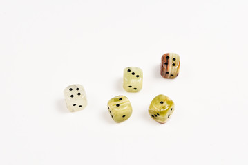 Dices made of natural stone on a white background. Copy space. Gaming.