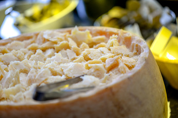 cheese sliced ​​in the head of cheese in a restaurant