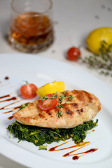 meat dish chicken cutlet on a pillow of spinach