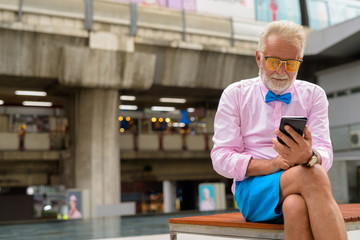 Handsome senior tourist man exploring the city of Bangkok, Thail