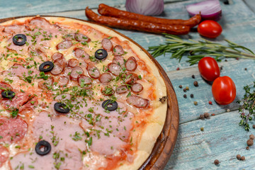 four meat pizza with olives