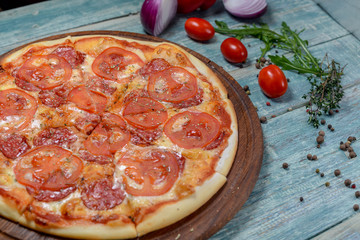 pizza with salami and tomatoes