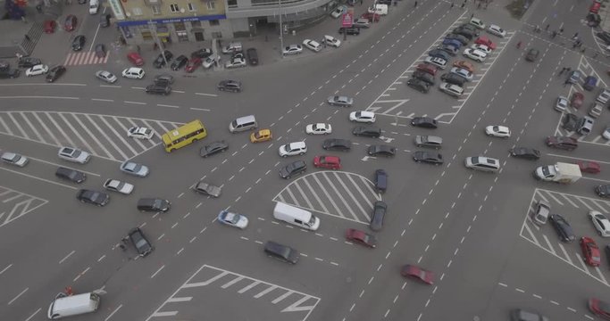 Aerial view of the road intersection, traffic at rush hour with cars on the road. Victory Square in the city of Kiev overloaded with public transport. Filmed from 4K drone in RAW. Video.