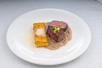 meat suvid on a plate in a beautiful flow from the chef