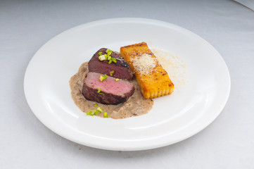 meat suvid on a plate in a beautiful flow from the chef