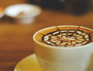 Mocha coffee in white cup on wood table