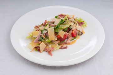 caesar salad on a white plate on a pure white background