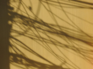 Obraz premium shadow of wire cable on brown street wall