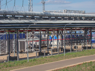 Metal constructions of an industrial enterprise. High-voltage power wires. Road lighting lanterns....