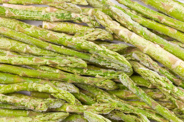 frozen asparagus on white cutting board, top view, macro